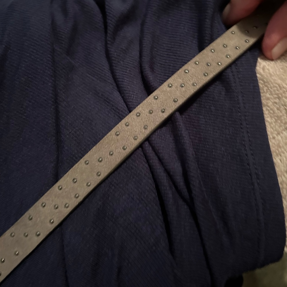 Leather belt size L with silver studs throughout.